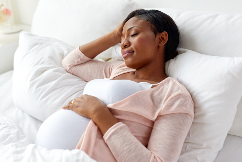 Pregnant woman in bed due to pelvic pain.